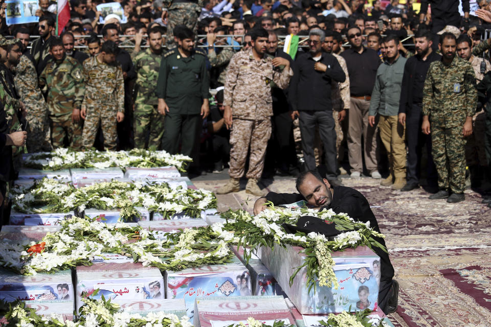 Father of Mohammad Taha Eghadami, a 4-year-old boy who was killed in Saturday's terror attack on a military parade, mourns over his coffin during a mass funeral ceremony for the victims, in southwestern city of Ahvaz, Iran, Monday, Sept. 24, 2018. Thousands of mourners gathered at the Sarallah Mosque on Ahvaz's Taleghani junction, carrying caskets in the sweltering heat. (AP Photo/Ebrahim Noroozi)