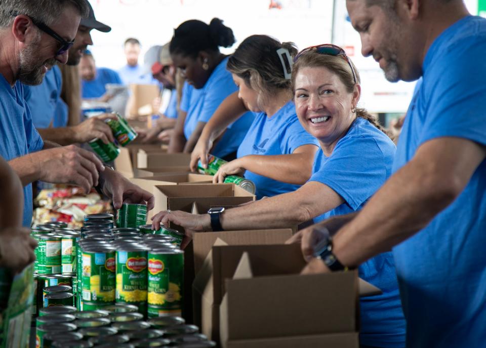 Sherri Kessinger and other volunteers pack boxes of food for Thanksgiving meals during the 19th Annual Capital Wealth Advisors Turkey Drop event on Monday, November 13, 2023 at First Baptist Church in Naples. The 3,136 meal boxes that were packed on Monday will be distributed by St. Matthew’s House to low-income families, those with disabilities, senior citizens and veterans starting on November 15th.