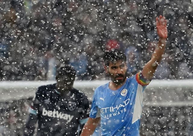 Manchester City's Ilkay Gundogan, right, celebrates his opening goal against West Ham