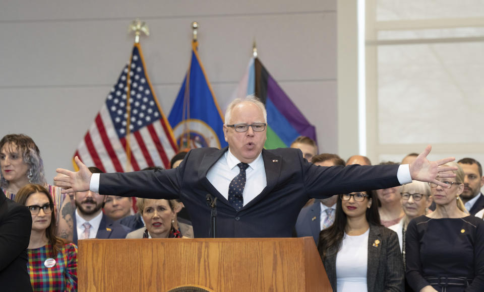 Minnesota Gov. Tim Walz, gestures where signed three progressive priorities, a ban on conversion therapy for minors and vulnerable adults, and two bills that would make Minnesota a refuge for people traveling here for abortion and gender affirming care, Thursday, April 27, 2023, in St. Paul, Minn. (Glen Stubbe/Star Tribune via AP)