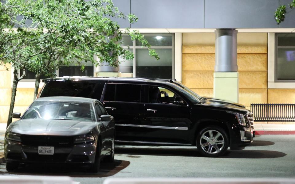 Mr Clinton's motorcade outside the hospital in Irvine - REUTERS