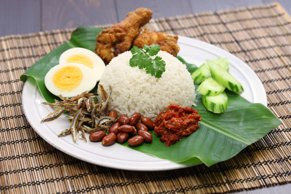 plate of nasi lemak sitting on a banana leaf