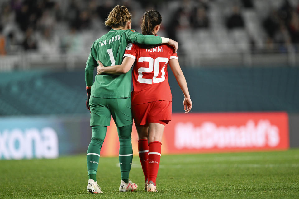 Switzerland's goalkeeper Gaelle Thalmann, left, and teammate Fabienne Humm embrace following the Women's World Cup second round soccer match between Switzerland and Spain at Eden Park in Auckland, New Zealand, Saturday, Aug. 5, 2023. (AP Photo/Andrew Cornaga)