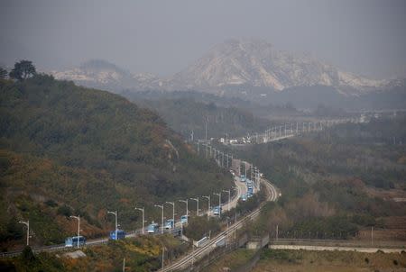 Buses transporting South Korean participants for a reunion travel on the road leading to North Korea's Mount Kumgang resort, in the demilitarized zone (DMZ) separating the two Koreas in this picture taken from the Unification Observatory, just south of the DMZ in Goseong, South Korea, October 20, 2015. REUTERS/Kim Hong-Ji TPX IMAGES OF THE DAY -