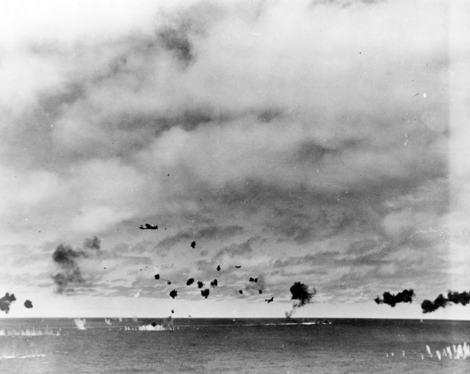 FILE - This June 4, 1942 file photo provided by the U.S. Navy shows Japanese Type 97 shipboard attack aircraft from the carrier Hiryu amid heavy anti-aircraft fire, during the torpedo attack on USS Yorktown (CV-5) in the mid-afternoon. Researchers scouring the world's oceans for sunken World War II ships are honing in on debris fields deep in the Pacific. A research vessel called the Petrel is launching underwater robots about halfway between the U.S. and Japan in search of warships from the Battle of Midway. (U.S. Navy via AP, File)