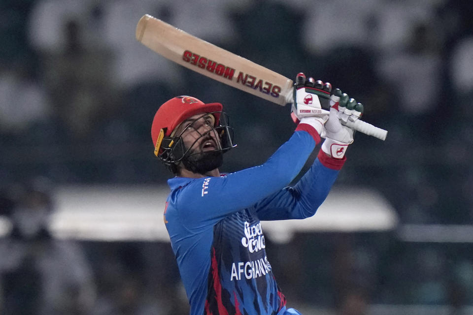 Afghanistan's Mohammad Nabi follows the ball after playing a shot for six during the Asia Cup cricket match between Afghanistan and Sri Lanka in Lahore, Pakistan, Tuesday, Sept. 5, 2023. (AP Photo/K.M. Chaudary)