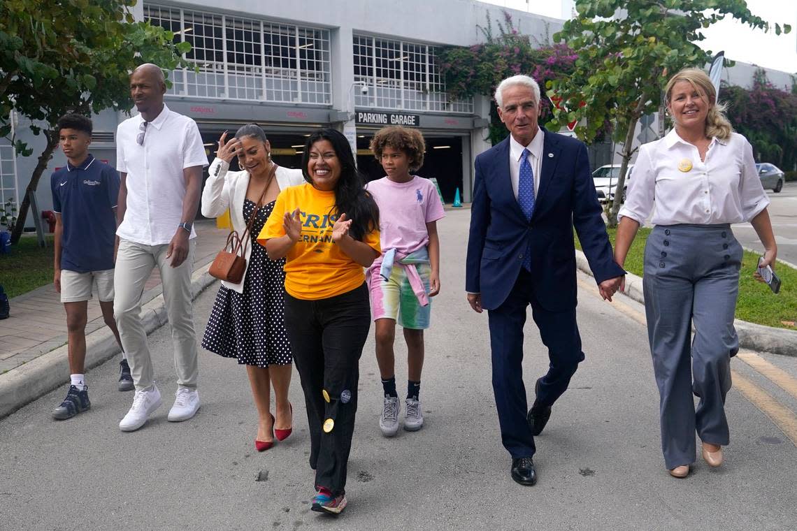 Democratic candidate for Florida governor Charlie Crist, second from right, arrives with his fiancee Chelsea Grimes, right, and his running mate Karla Hernandez-Mats, center, as he campaigns at an early voting location, Sunday, Nov. 6, 2022, in Miami. Second from left is former Miami Heat player Ray Allen. Lynne Sladky/AP