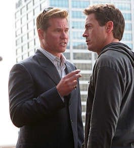 Actor Val Kilmer, left, plays a private detective who is hired to train a hood-turned-actor, played by real-life actor Robert Downey Jr., right, for a movie role in "Kiss Kiss, Bang Bang." | Associated Press