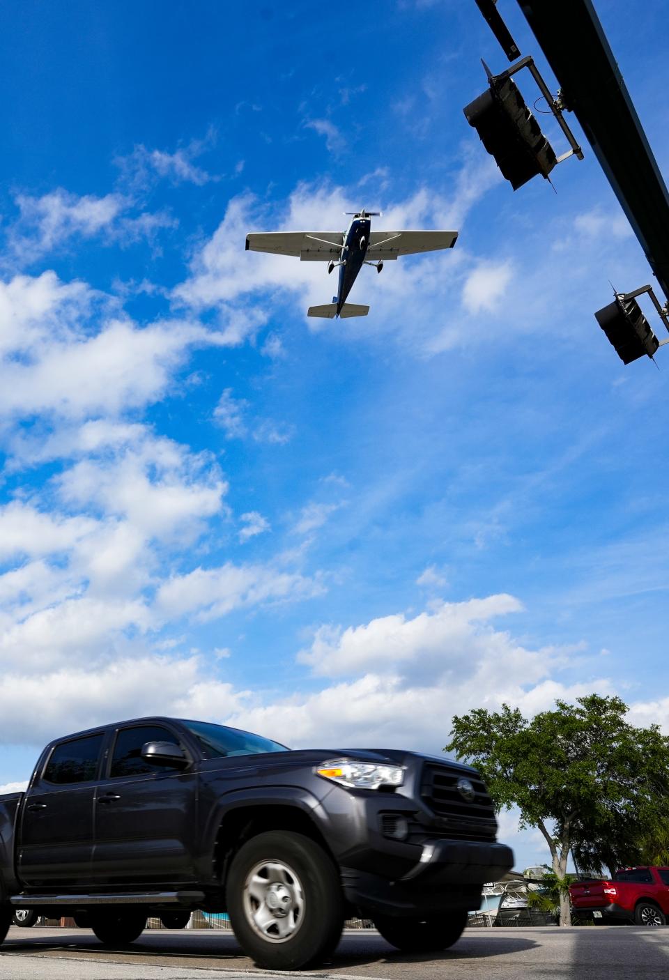 Planes approach to land at the Naples Airport as cars drive along Airport-Pulling Road on Thursday, March 14, 2024.