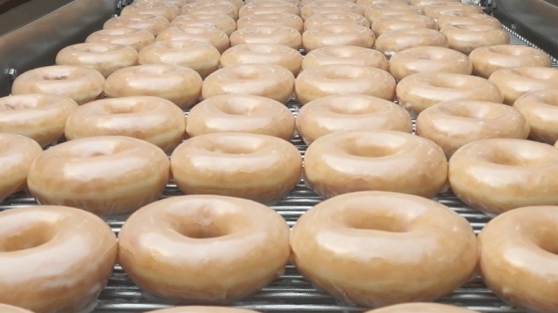 GIF of Krispy Kreme original glazed doughnuts on conveyer belt