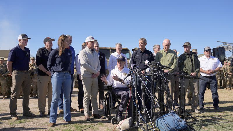 Utah Gov. Spencer Cox, far left, listens as Texas Gov. Greg Abbott, seated center, is joined by fellow governors during a news conference along the Rio Grande to discuss Operation Lone Star and border concerns, Sunday, Feb. 4, 2024, in Eagle Pass, Texas. Abbott was joined by Arkansas Gov. Sarah Huckabee Sanders, Georgia Gov. Brian Kemp, Idaho Gov. Brad Little, Indiana Gov. Eric Holcomb, Iowa Gov. Kim Reynolds, Louisiana Gov. Jeff Landry, Mississippi Gov. Tate Reeves, Missouri Gov. Mike Parson, Montana Gov. Greg Gianforte, Nebraska Gov. Jim Pillen, New Hampshire Gov. Chris Sununu, South Dakota Gov. Kristi Noem and Tennessee Gov. Bill Lee.