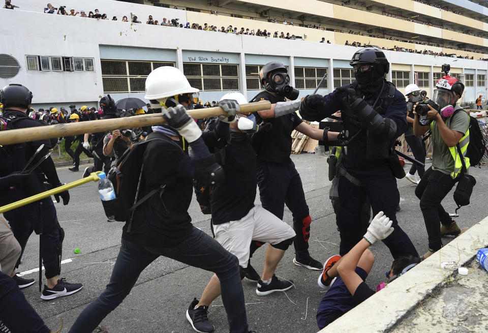 Police and demonstrators clash during a protest in Hong Kong, Saturday, Aug. 24, 2019. Chinese police said Saturday they released an employee at the British Consulate in Hong Kong as the city's pro-democracy protesters took to the streets again, this time to call for the removal of "smart lampposts" that raised fears of stepped-up surveillance. (AP Photo/Vincent Yu)