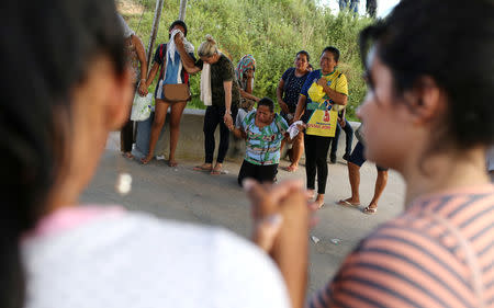 Relatives of inmates react in front of a prison complex in the Brazilian state of Amazonas after prisoners were found strangled to death in four separate jails, according to the penitentiary department in Manaus, Brazil May 27, 2019. REUTERS/Bruno Kelly