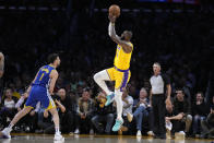 Los Angeles Lakers forward LeBron James, right, shoots as Golden State Warriors guard Klay Thompson defends during the first half in Game 4 of an NBA basketball Western Conference semifinal Monday, May 8, 2023, in Los Angeles. (AP Photo/Marcio Jose Sanchez)