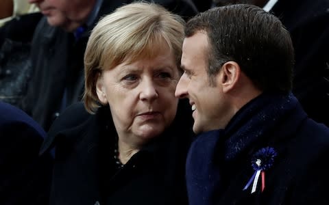 French President Emmanuel Macron and German Chancellor Angela Merkel at the ceremony commemorating the end of the First World War - Credit: BENOIT TESSIER/REUTERS