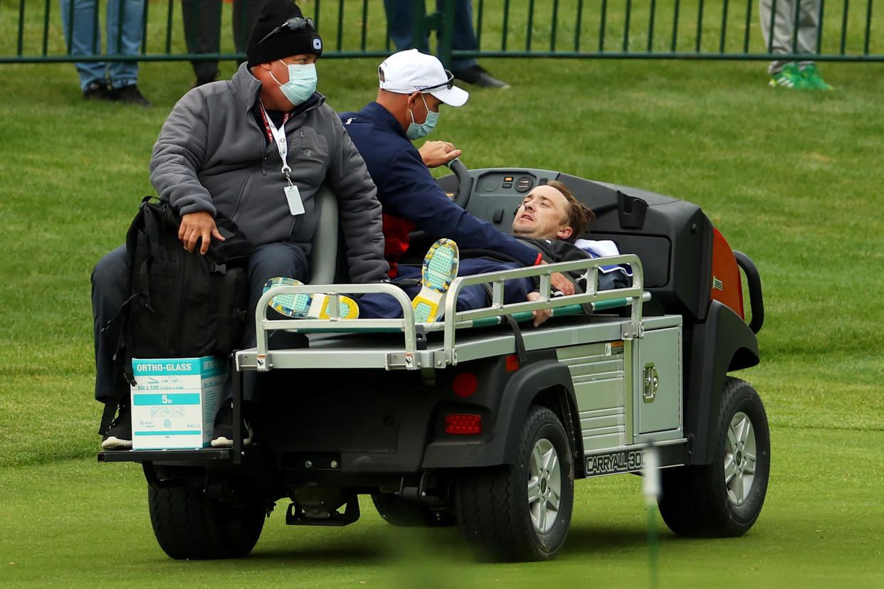 KOHLER, WISCONSIN - SEPTEMBER 23: Tom Felton is carted off the course after collapsing during the celebrity matches ahead of the 43rd Ryder Cup at Whistling Straits on September 23, 2021 in Kohler, Wisconsin. (Photo by Andrew Redington/Getty Images)