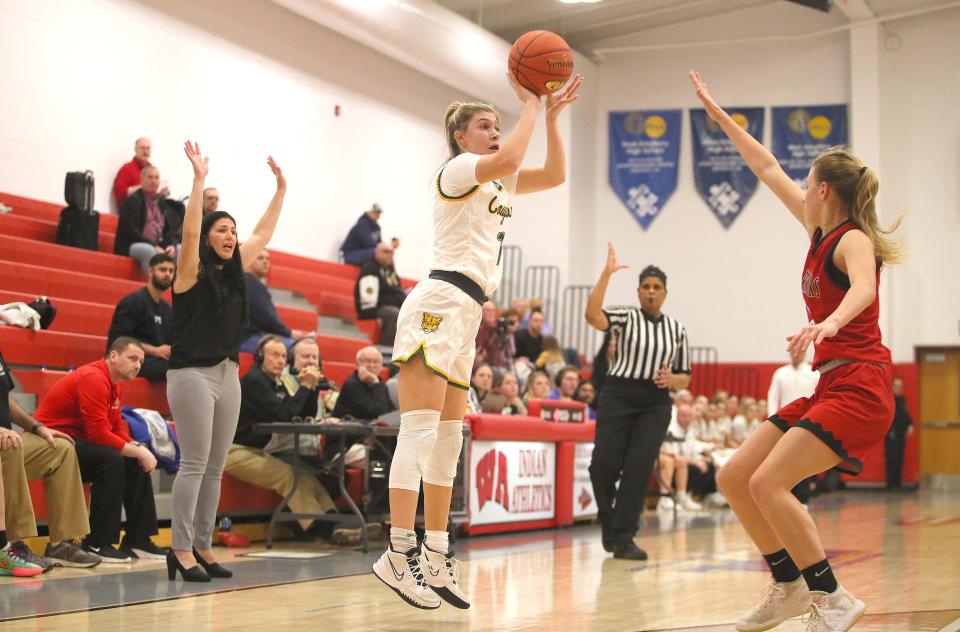 Blackhawk's Alena Fusetti (11) shoots a three point shot while being guarded by Elizabeth Forward's Brooke Markland (12) during the first half of the WPIAL 4A Semifinals game Tuesday night at West Allegheny.