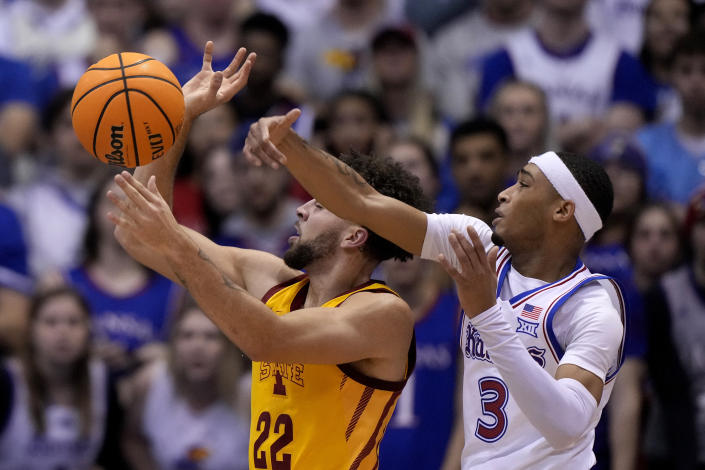 Kansas guard Dajuan Harris Jr. (3) knocks the ball away from Iowa State guard Gabe Kalscheur (22) during the first half of an NCAA college basketball game Saturday, Jan. 14, 2023, in Lawrence, Kan. (AP Photo/Charlie Riedel)