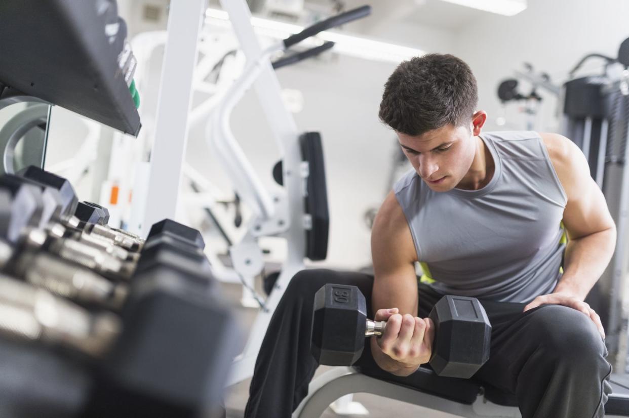 young man working out at gym, jersey city, new jersey, usa