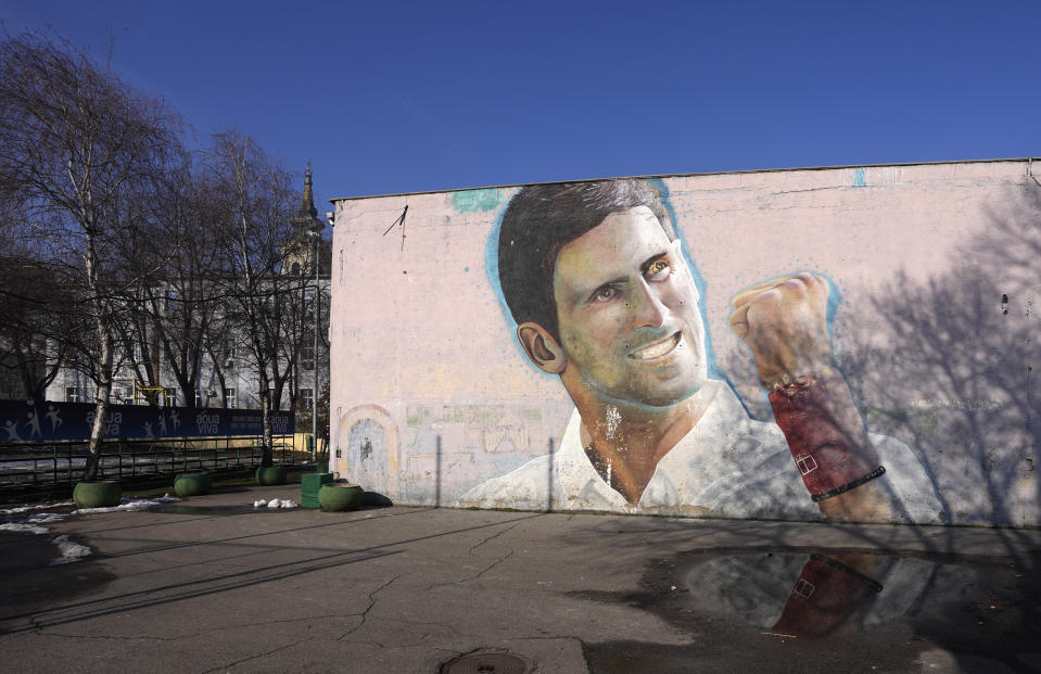 A mural depicting Serbian tennis player Novak Djokovic on a wall in Belgrade, Serbia, Sunday, Jan. 16, 2022. Novak Djokovic was preparing to leave Australia on Sunday evening after losing his final bid to avoid deportation and play in the Australian Open despite being unvaccinated for COVID-19. A court earlier unanimously dismissed the No. 1-ranked tennis player's challenge to cancel his visa. (AP Photo/Darko Vojinovic)