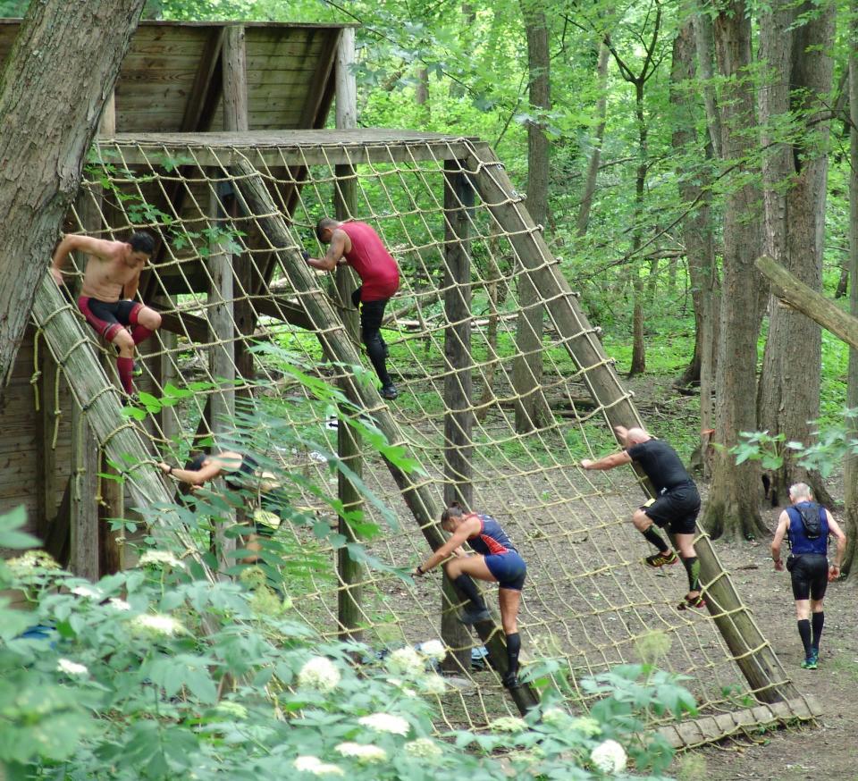 Participants in the 2021 Indian Mud Run at Lake Park on Ohio 83 climb down one of the more than 80 obstacles that dotted the 6.6 mile course. The adult obstacle course is a major summer attraction.