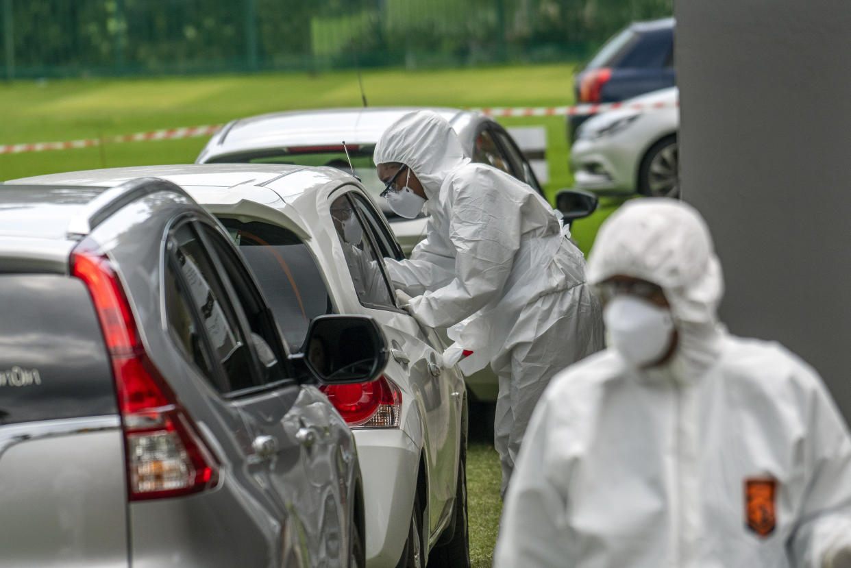 Cars line up at a private COVID-19 testing station in the northern suburbs of Johannesburg , South Africa, Wednesday April 1, 2020. South Africa went into a nationwide lockdown for 21 days in an effort to control the spread of the coronavirus, and patrols have increased in the streets to enforce the lockdown. The new coronavirus causes mild or moderate symptoms for most people, but for some, especially older adults and people with existing health problems, it can cause more severe illness or death. (AP Photo/Jerome Delay)