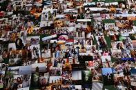 Photographs are seen on a table at the Cavallerizza Reale building, which is occupied by the "Assemblea Cavallerizza 14:45" movement in Turin, Italy, July 22, 2016. REUTERS/Marco Bello