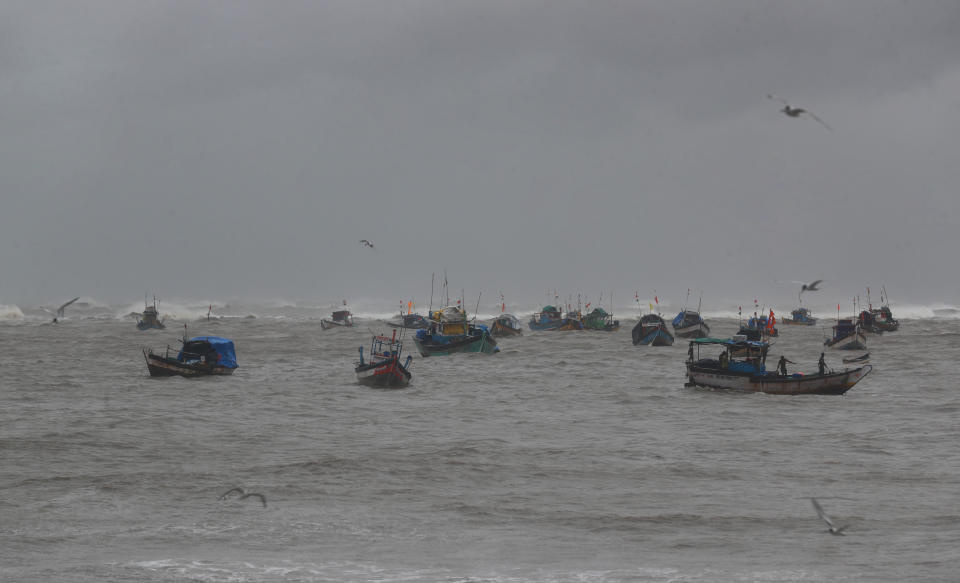 Fishermen try to return to the shores on the Arabian Sea coast in Mumbai, India, Monday, May 17, 2021. Cyclone Tauktae, roaring in the Arabian Sea was moving toward India's western coast on Monday as authorities tried to evacuate hundreds of thousands of people and suspended COVID-19 vaccinations in one state. (AP Photo/Rafiq Maqbool)