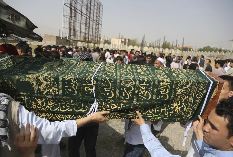 Men carry the coffin of a relative who died in Wednesday's deadly suicide bombing that targeted a training class in a private building in the Shiite neighborhood of Dasht-i Barcha, in western Kabul, Afghanistan, Thursday, Aug. 16, 2018. The Afghan authorities have revised the death toll from the previous day's horrific suicide bombing in a Shiite area of Kabul to 34 killed. (AP Photo/Rahmat Gul)