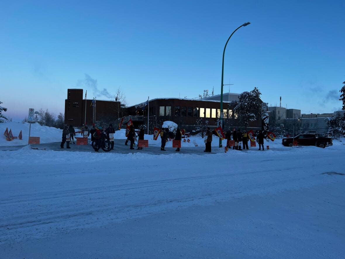 Striking workers picket Yellowknife City Hall early Wednesday morning, the first day of a municipal strike in the capital.  (Hilary Bird/CBC - image credit)