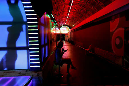 A woman sits outside a go-go dance bar in Pattaya, Thailand March 25, 2017. REUTERS/Jorge Silva