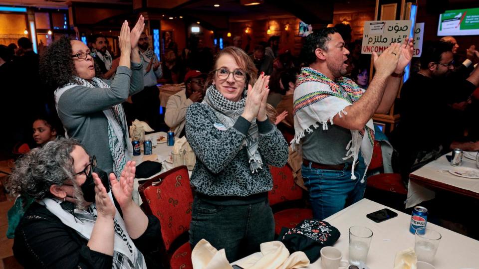 PHOTO: People cheer for preliminary election results at the People hug at the Listen to Michigan watch party, a group who asked voters to vote uncommitted instead of for President Joe Biden in Michigan's primary election, in Dearborn, Mi., Feb. 27, 2024.  (Jeff Kowalsky/AFP via Getty Images)