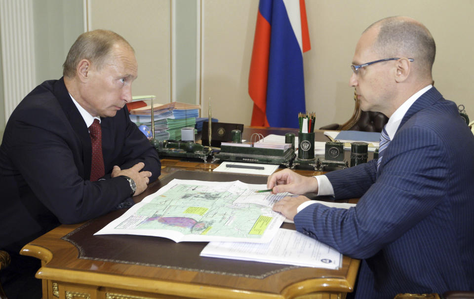 Russia's Prime Minister Vladimir Putin (L) meets with Chief of Russian state nuclear corporation Rosatom Sergei Kiriyenko