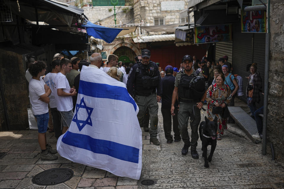 Israelis walk with national flags shortly before a march marking Jerusalem Day, in Jerusalem's Old City, Thursday, May 18, 2023. The parade was marking Jerusalem Day, an Israeli holiday celebrating the capture of east Jerusalem in the 1967 Mideast war. Palestinians see the march as a provocation. (AP Photo/Ohad Zwigenberg)