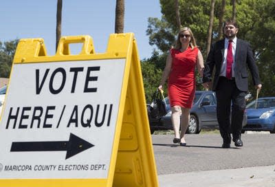Democrat Ruben Gallego arrives to drop off his early primary ballot with his wife, Phoenix Councilwoman Kate Gallego, at Valley View School in Phoenix August 26, 2014. Gallego is running in the primary for Congress in the 7th District to replace retiring U.S. Rep. Ed Pastor