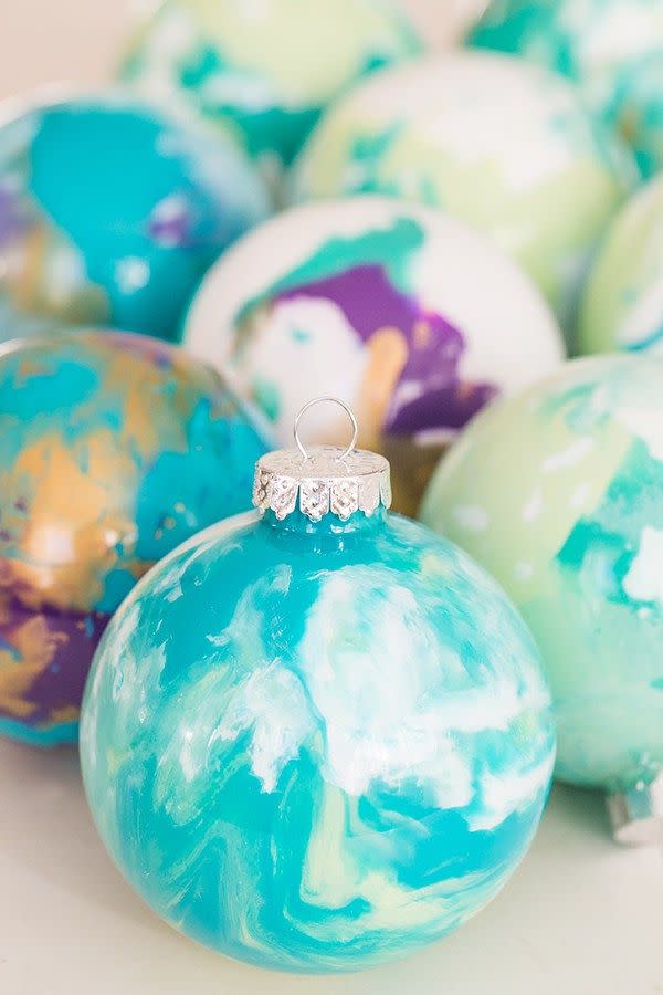 <p>Christmas tree ornaments are so much more special when they have sentimental value. Make your own marbled ornaments with this guide from <a href="https://sugarandcharm.com/diy-marbled-ornaments" rel="nofollow noopener" target="_blank" data-ylk="slk:Sugar and Charm;elm:context_link;itc:0;sec:content-canvas" class="link ">Sugar and Charm</a>. </p>