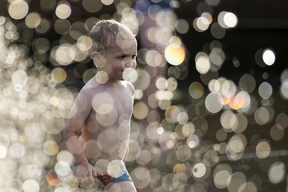 A child cools off in a fountain in Moscow, Russia, June 30, 2024. (AP Photo/Alexander Zemlianichenko)