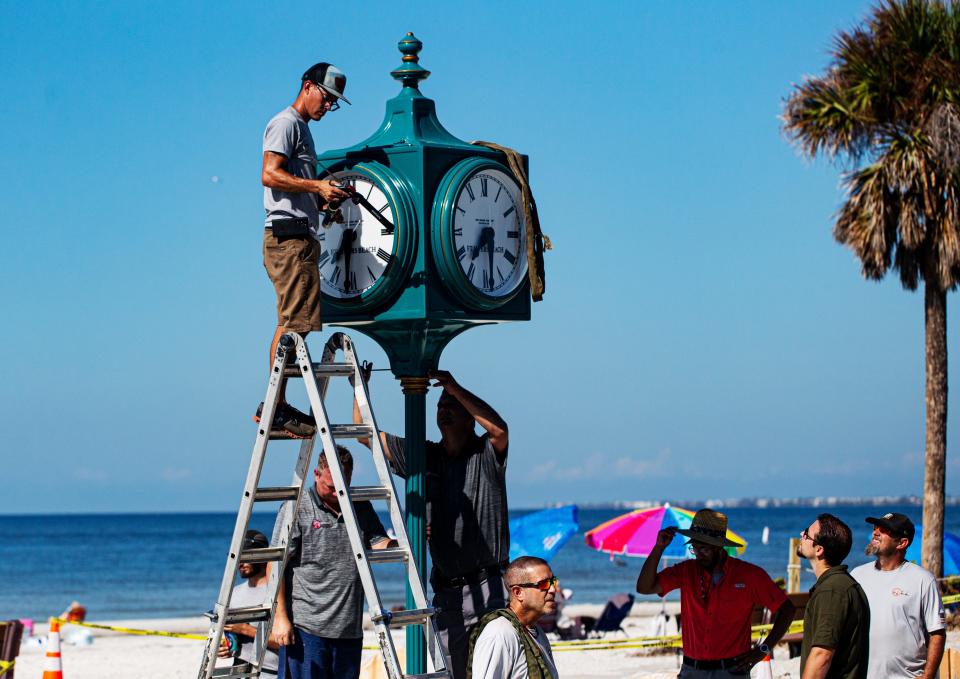 Crews with the Verdin Company and Kelly General Contracting install the new clock in Times Square on Fort Myers Beach on Thursday, Sept. 14, 2023. The original clock was destroyed after Hurricane Ian decimated the island on Sept. 28, 2022. The clock will be covered until it is unveiled during a ceremony on Sept. 28, 2023.
(Credit: Andrew West/The News-Press)