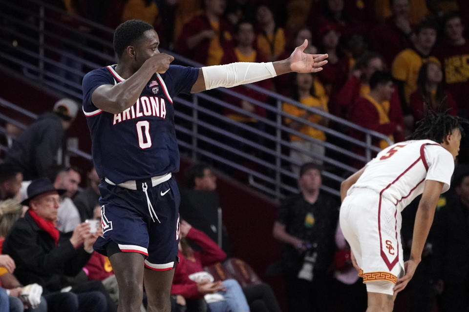 Arizona guard Courtney Ramey, left, gestures after scoring as Southern California guard Boogie Ellis stands by during the second half of an NCAA college basketball game Thursday, March 2, 2023, in Los Angeles. (AP Photo/Mark J. Terrill)