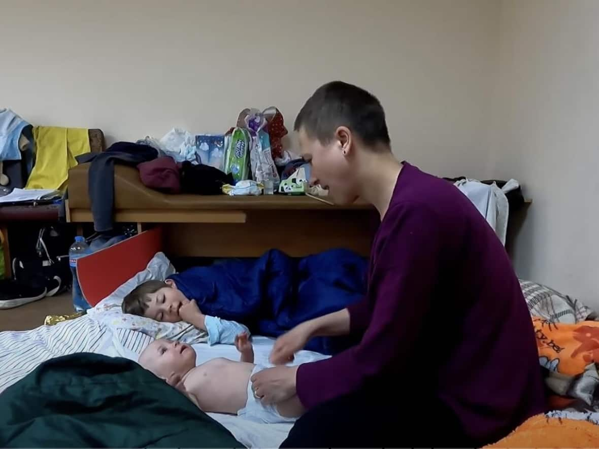 Olena Gnes, a YouTube vlogger and tour guide in Kyiv, took to a bomb shelter with her three children when Russia's war on Ukraine began in February 2022.  (Submitted by Olena Gnes - image credit)