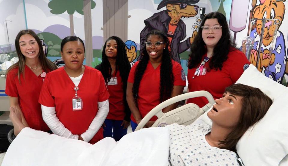 Columbus State University nursing students gather around “Victoria,” the mannequin mom that’s part of the new mother-baby simulation lab at CSU’s School of Nursing. 03/28/2024