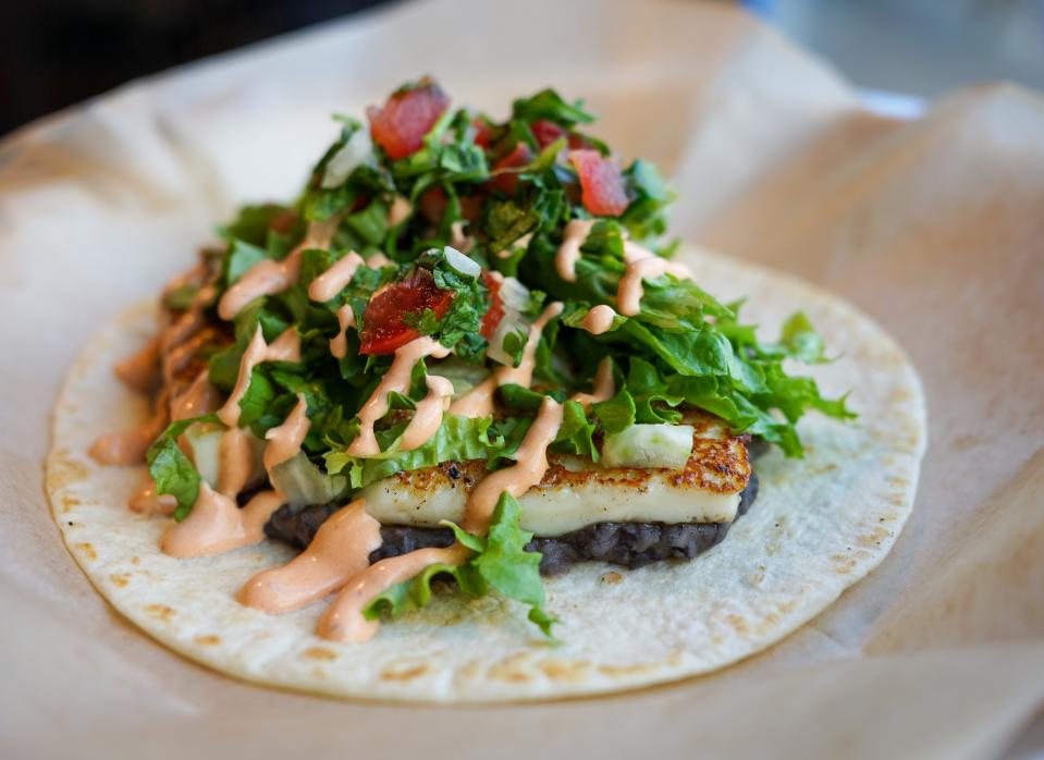 Taco Billy's Little Sister is made with grilled queso fresco, refried black beans, lettuce, pico de gallo and chipotle crema on a flour tortilla.
