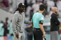 Senegal's head coach Aliou Cisse talks with an assistant referee during the World Cup group A soccer match between Qatar and Senegal, at the Al Thumama Stadium in Doha, Qatar, Friday, Nov. 25, 2022. (AP Photo/Thanassis Stavrakis)