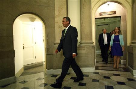 U.S. House Speaker John Boehner (L) departs his office with his staff to go to the House floor for a series of votes on partial budget measures to send to the Democratic-controlled Senate at the U.S. Capitol in Washington October 1, 2013. REUTERS/Jonathan Ernst
