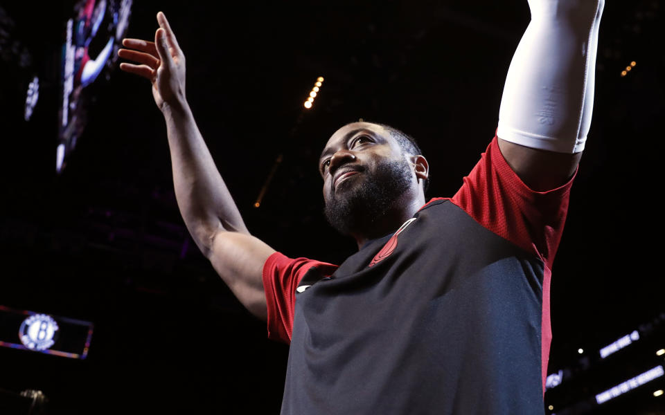 Miami Heat guard Dwyane Wade (3) acknowledges cheers from the crowd before the start of the final NBA basketball game of his career, Wednesday, April 10, 2019, against the Brooklyn Nets in New York. (AP Photo/Kathy Willens)