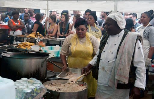 Chefs cook street food at the at the Notting Hill Carnival on August 27. A multi-ethnic throng milled between the stalls and thumping sound systems, drinking, dancing, and tasting jerk chicken as the smells of open-cooked food wafted through the air