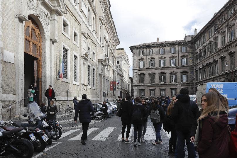 People stand outside an evacuated school after three earthquakes hit central Italy in the space of an hour, shaking the same region that suffered a series of deadly quakes last year, in Rome, Wednesday, Jan. 18, 2017. There were no immediate reports of casualties but tremors were felt as far away as Rome, where the subway was closed as a precaution and parents were asked to pick up their children early from schools. (AP Photo/Gregorio Borgia)