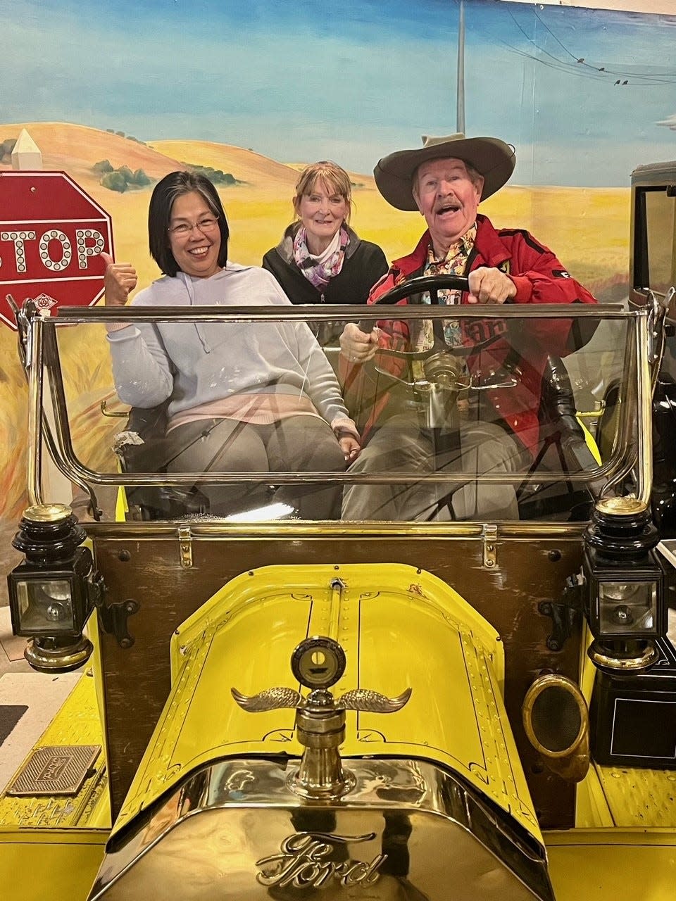 Ron and Sandar Grant, with Susan Viall in back, pose in Model T at California Auto Museum.