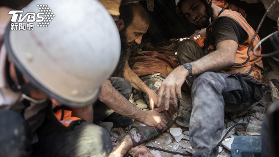 巴勒斯坦民眾正在廢墟中搶救一位受困婦女（圖／達志影像美聯社）