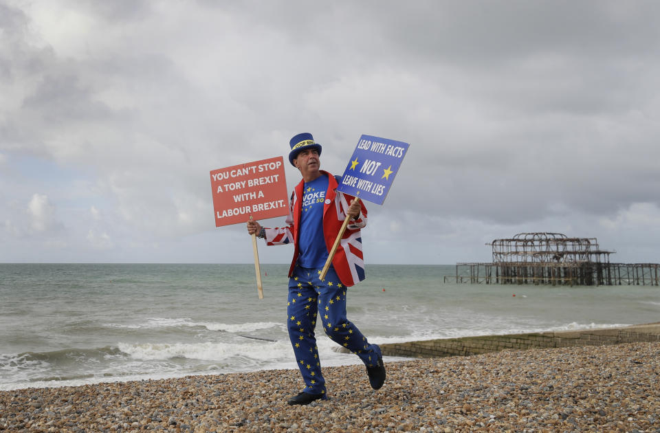 Anti Brexit campaigner Steve Bray walks on the beach to pose for a photograph during the Labour Party Conference at the Brighton Centre in Brighton, England, Monday, Sept. 23, 2019. (AP Photo/Kirsty Wigglesworth)